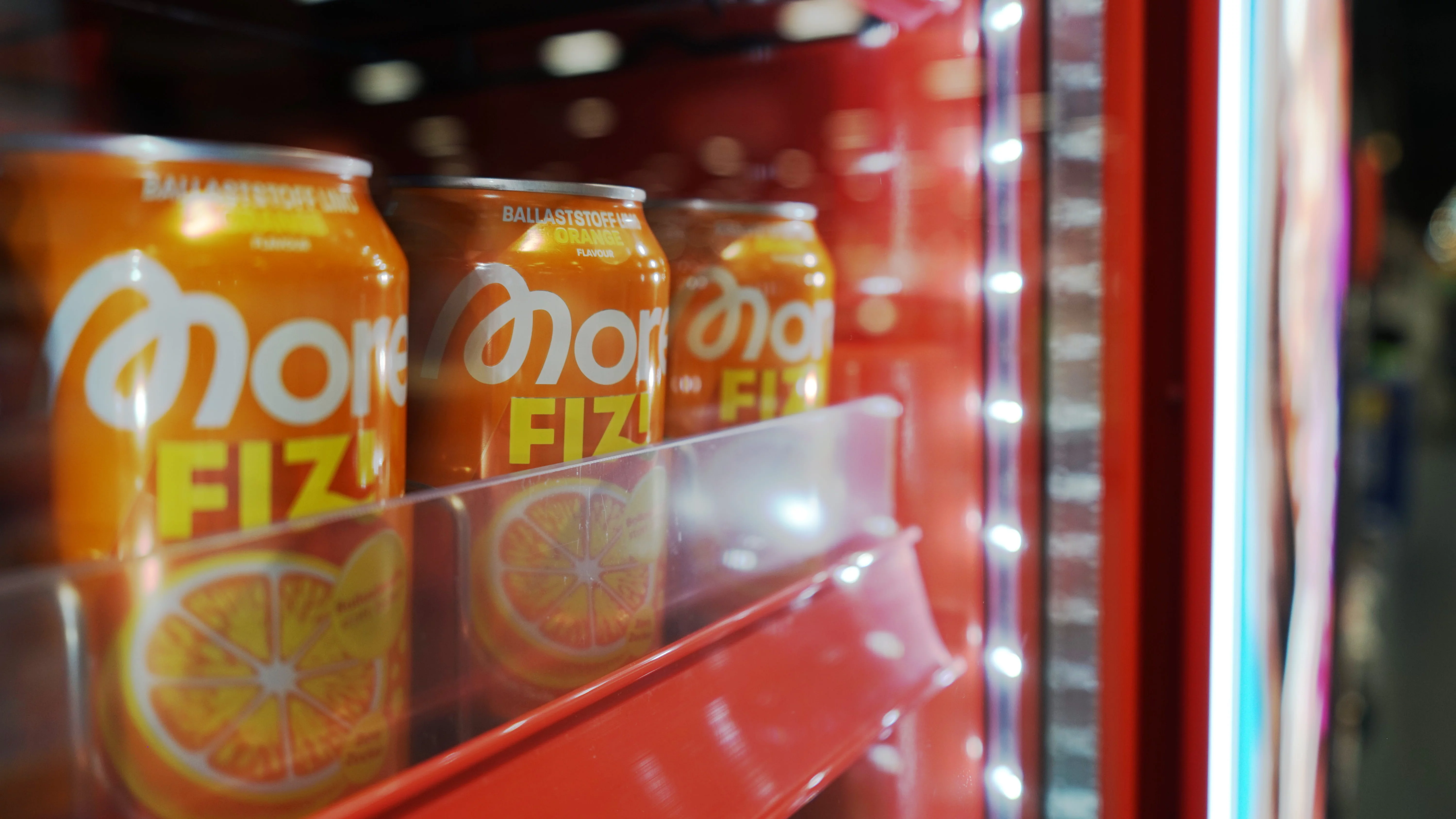 orange cans in a red freezer