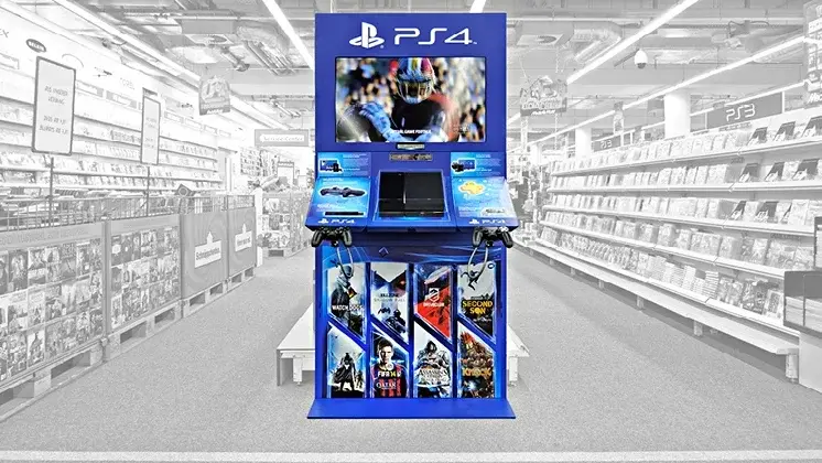 PlayStation 4 kiosk showcasing games in an electronics store aisle