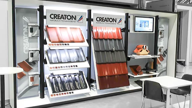 Roof tiles displayed on stands in a showroom with seating area