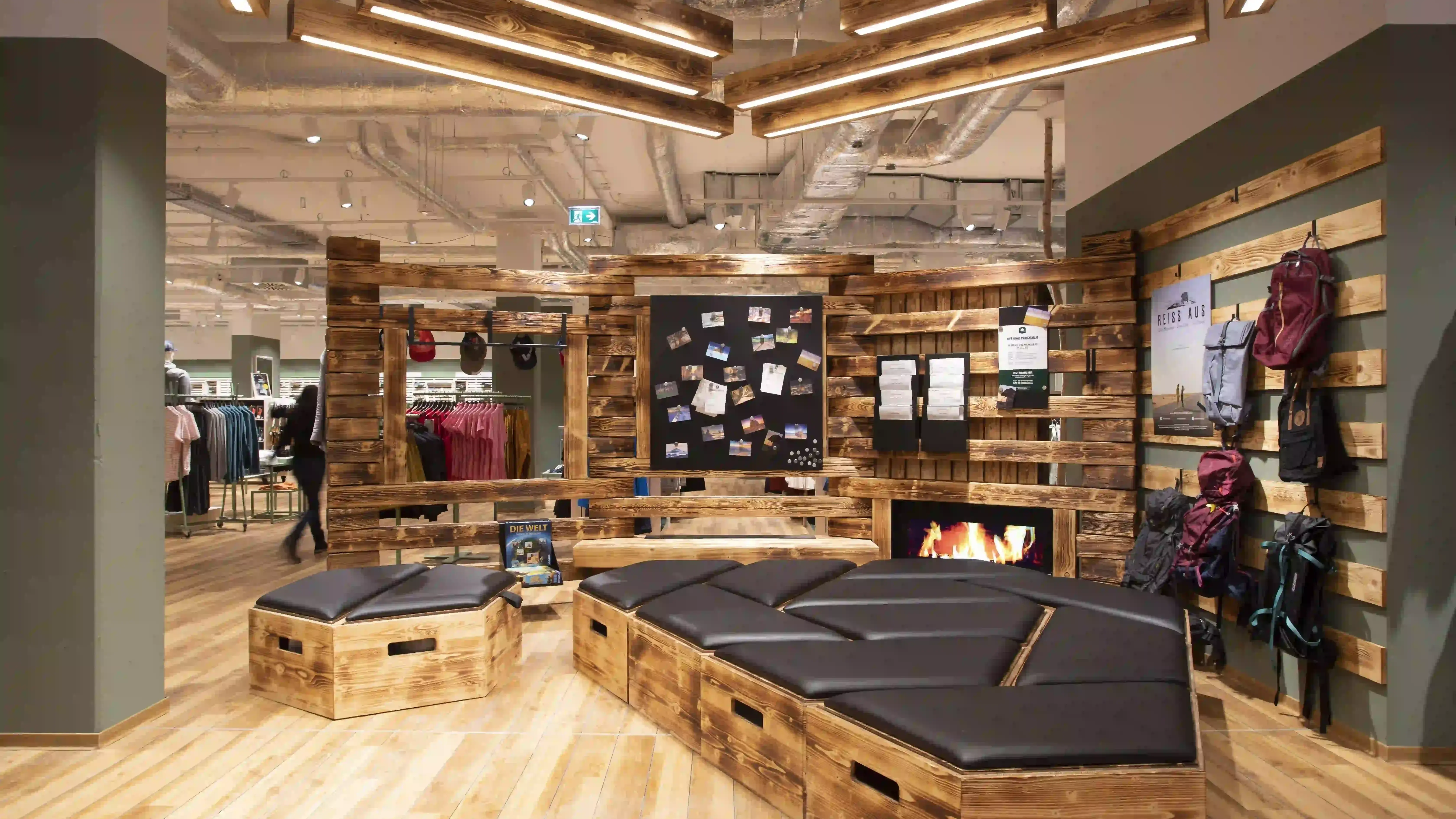 Wooden seating area displays clothing, store interior