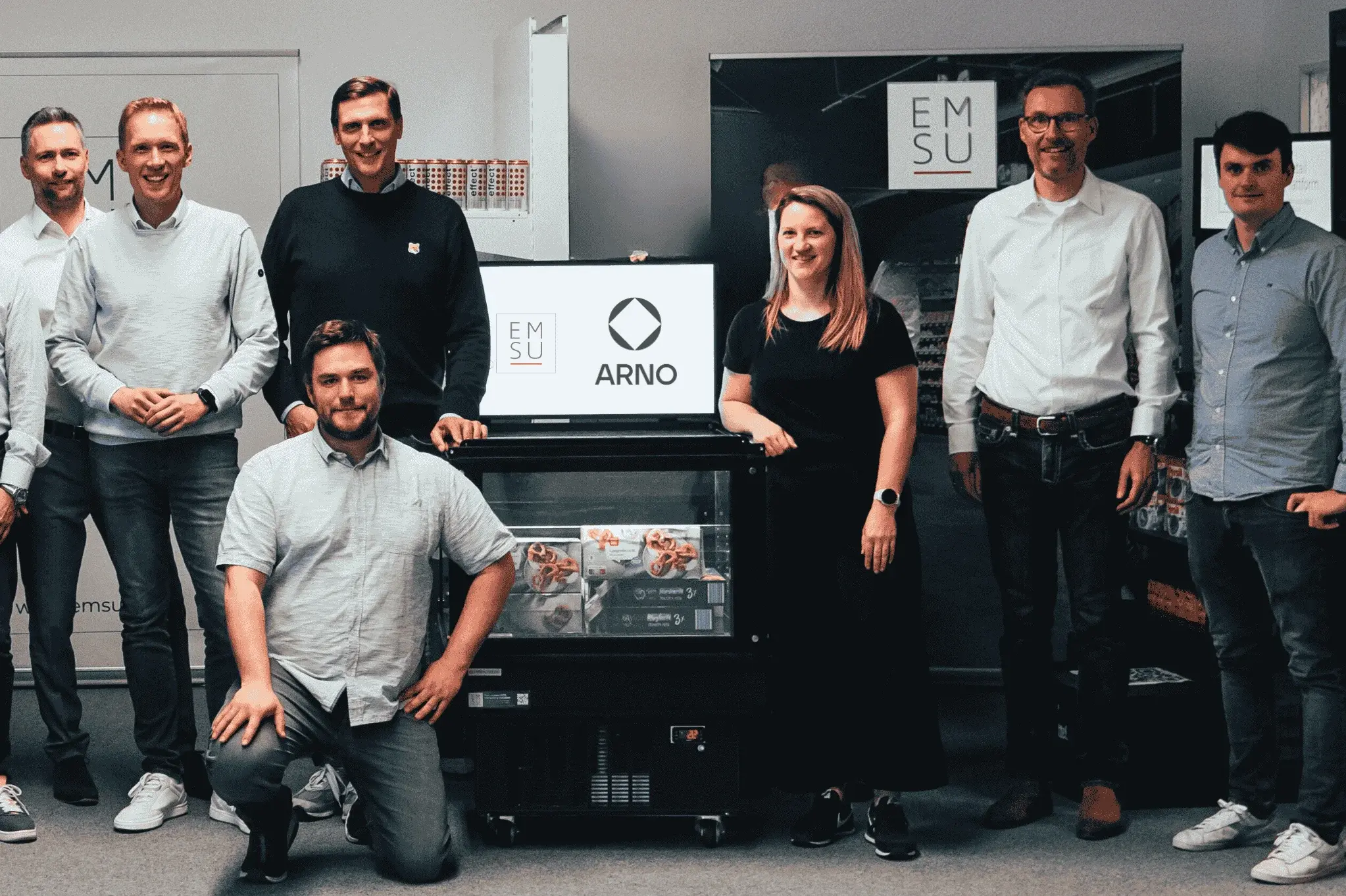 group picture of ARNO and EMSU team members standing beside cooling unit