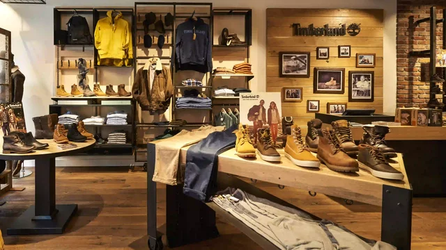 Mannequin displaying clothing in a stylish, modern shoe store interior