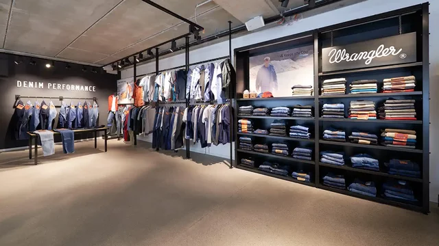 Jeans displayed on racks and shelves in a store
