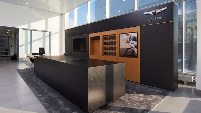 Reception desk stands in modern showroom with large windows and sleek design