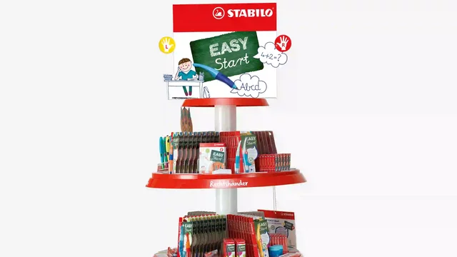 Pens and pencils displayed on a three-tiered stand, retail setting