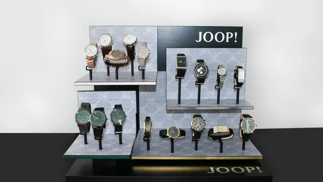 Watches displayed on tiered stand in retail setting