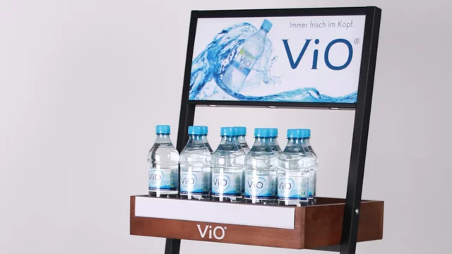 Water bottles displayed on wooden shelf unit