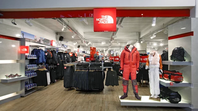 Mannequins display winter gear inside a brightly lit outdoor apparel store
