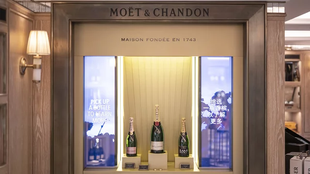 Champagne bottles displayed in elegant wooden shop