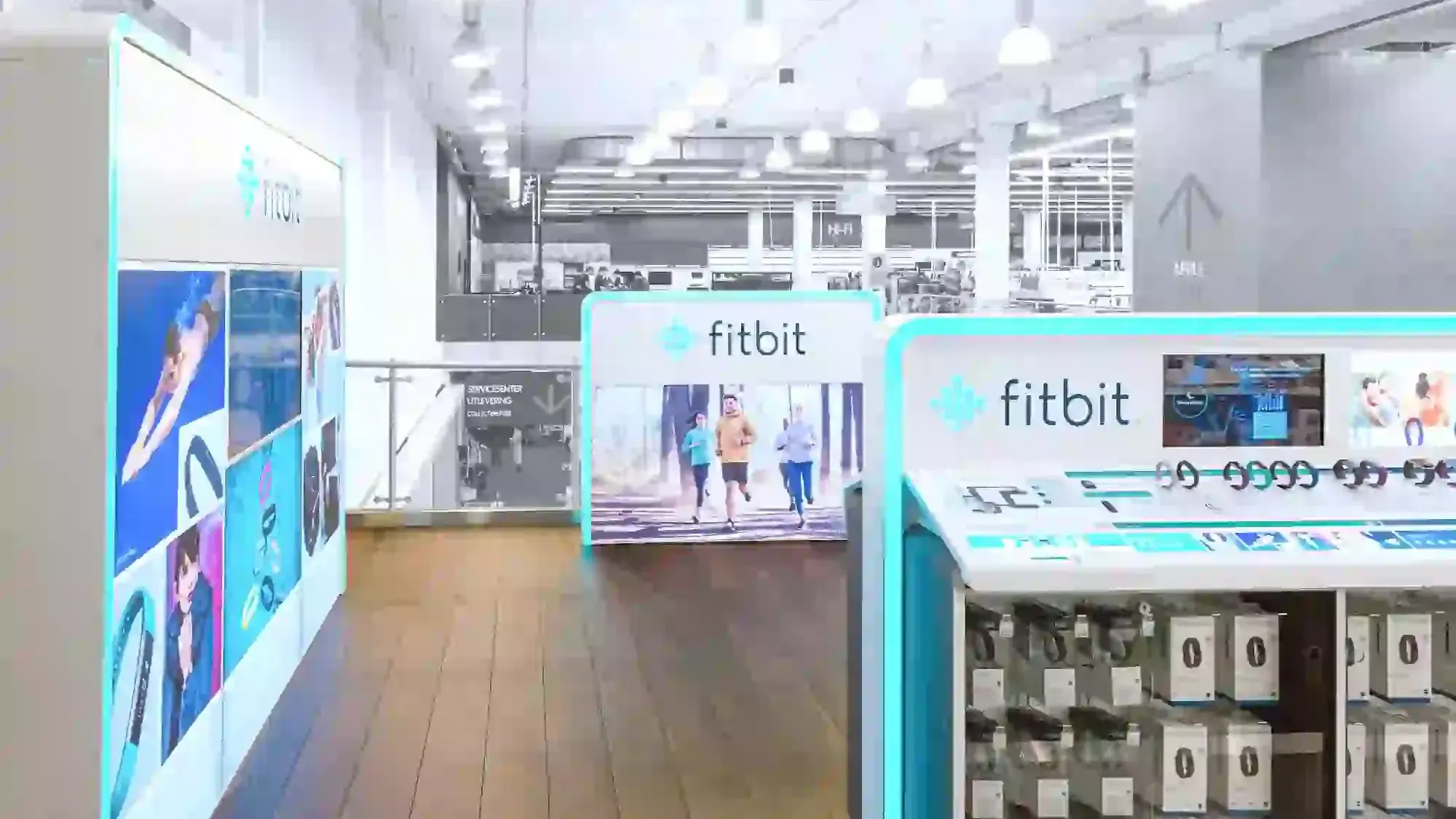 Fitbit displays promoting fitness devices in a bright indoor retail store