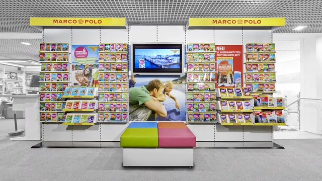 Guidebooks displayed on a store wall with colorful bench seating
