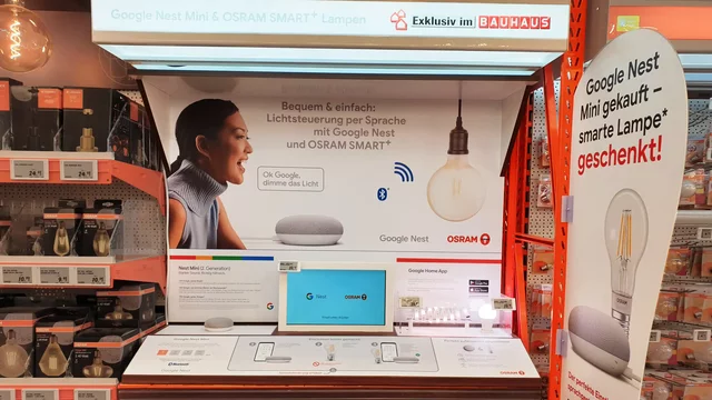 Smart speaker displayed on a retail shelf amidst electronic accessories