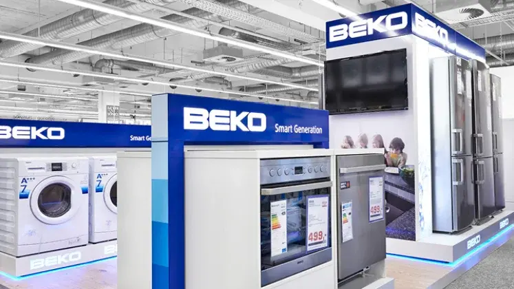 Washing machines and appliances displayed inside modern showroom with bright lighting