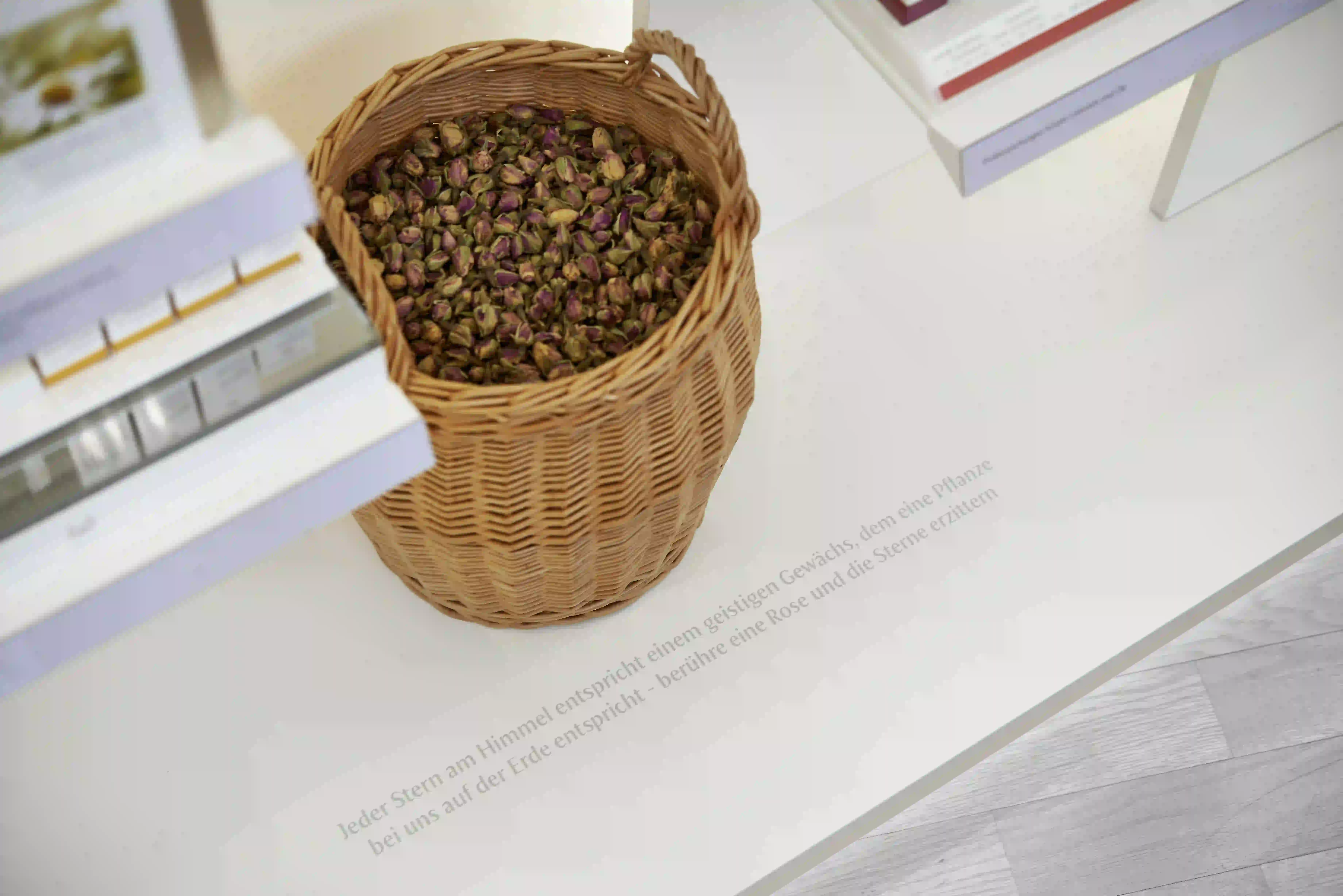 Wicker basket holds dried rosebuds on table